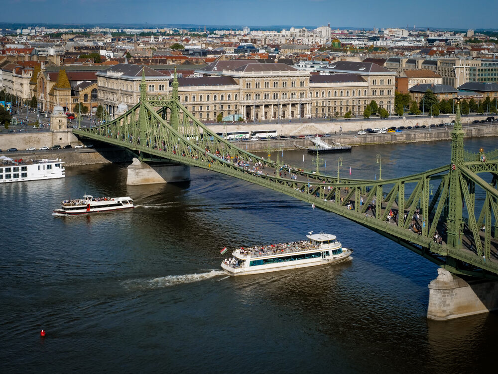 Liberty Bridge over the Danube with sightseeing boats passing beneath, Budapest