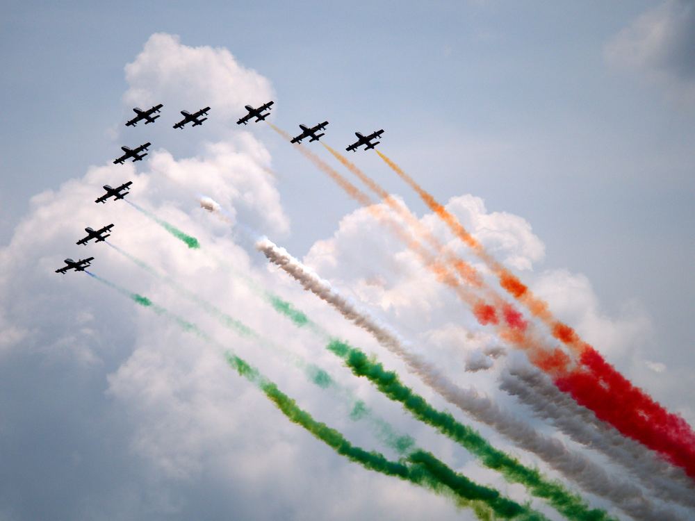 Aerobatic formation trailing tricolour smoke over Rome