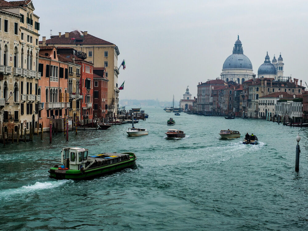 View down the Grand Canal from the Accademia bridge toward the domes of Santa Maria della Salute in winter haze, Venice